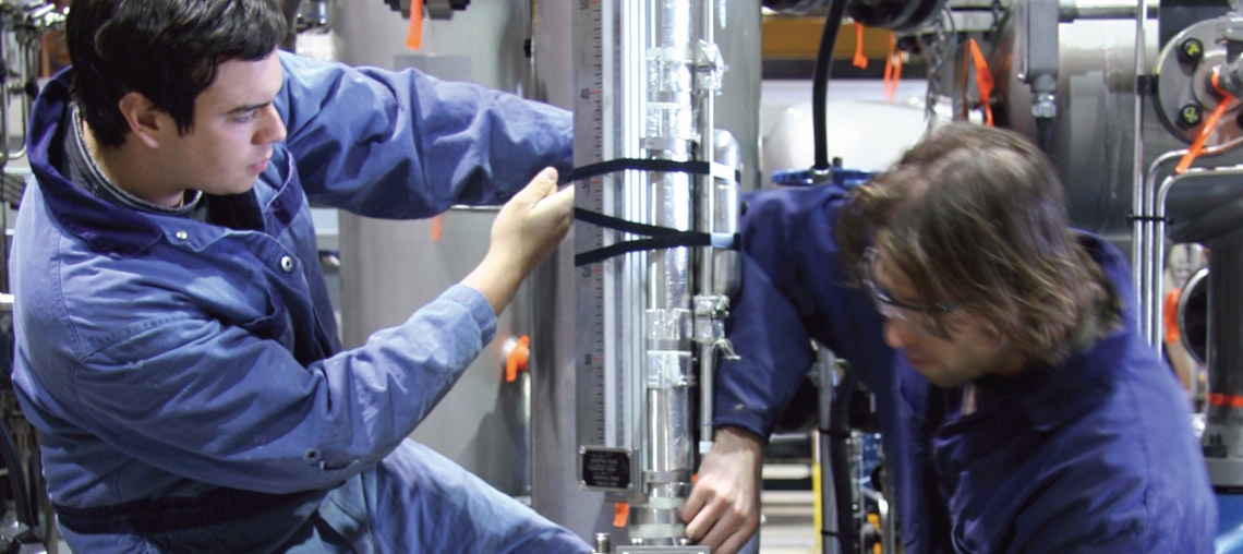 Two Engineering Apprentices using machinery